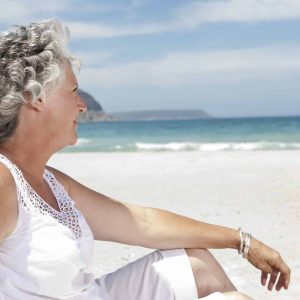 Older woman relaxing on beach
